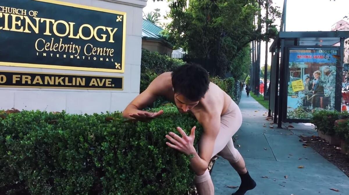 A screenshot from the video of a ballet dancer dancing to Hozier's "Take Me To Church" in various spots around Los Angeles.