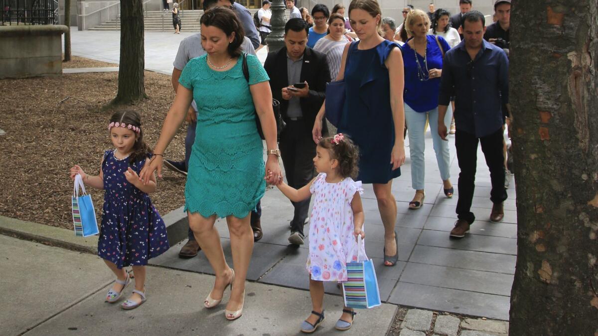 Pablo Villavicencio's wife Sandra Chica leaves federal court with their daughters after a hearing on his release on July 24 in New York.
