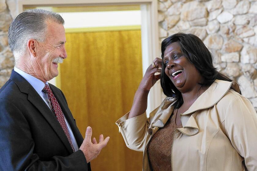 L.A. County sheriff candidate Bob Olmsted talks with Dr. Lestean Johnson, president of the Compton Chamber of Commerce, before a candidate forum earlier this month.