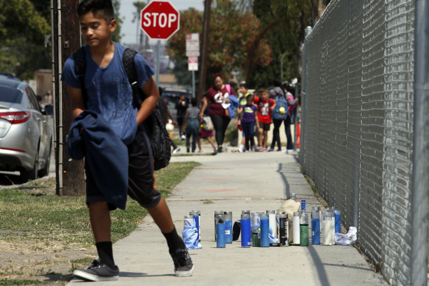 A student walks past a memorial for shooting victim Anthony Alexander as school lets out at Robert F. Kennedy Elementary on West Caldwell Street in Compton. The shooting happened next to the school.