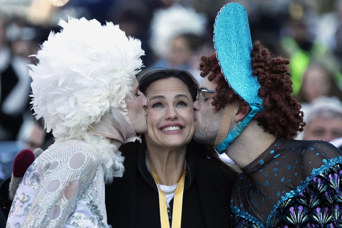 Members of Harvard University's Hasty Pudding Theatricals honor Jennifer Garner, center, as "Woman of the Year" during a parade, Saturday, Feb. 5, 2022, in Cambridge, Mass. (AP Photo/Michael Dwyer)