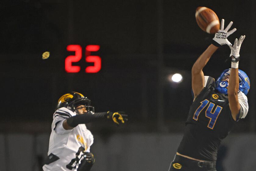 Roberto Salazar of Crenshaw goes up trying to pull down pass during 28-6 win over King/Drew.