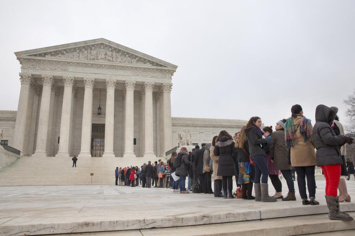People stand in line hoping to enter the Supreme Court in Washington, on Dec. 9, as the court hears oral arguments in the Fisher v. University of Texas at Austin affirmative action case.