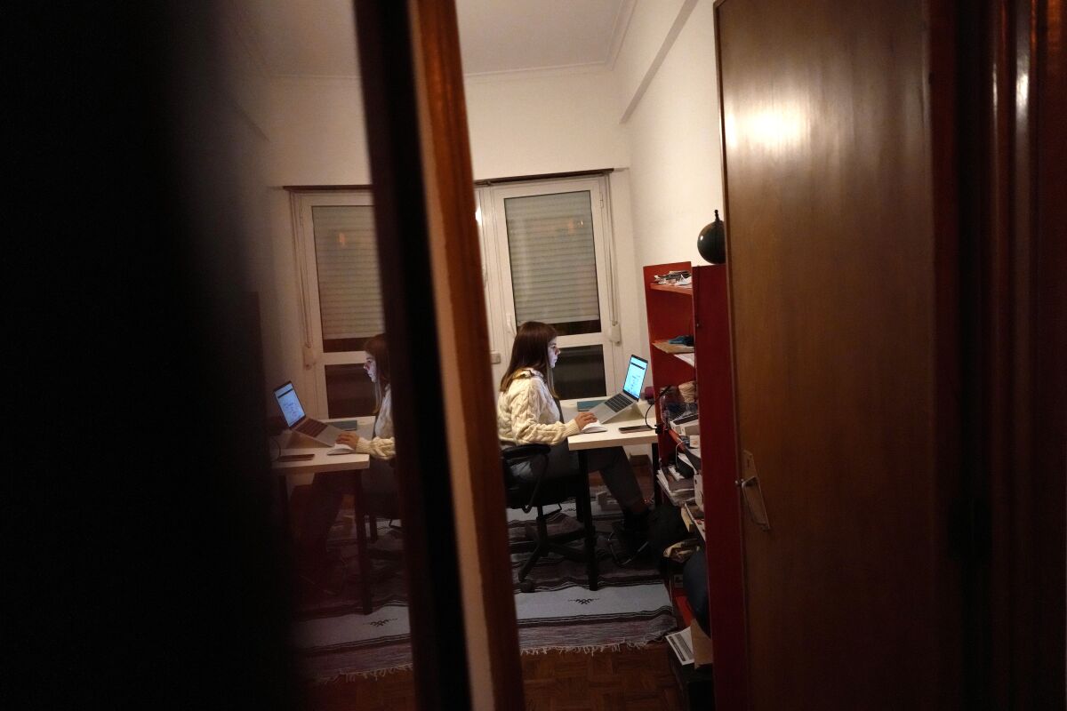 A woman sits at her computer as she works from home