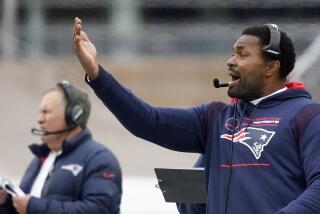 Patriots linebackers coach Jerod Mayo gestures on the sideline during a game. Coach Bill Belichick is in the background.