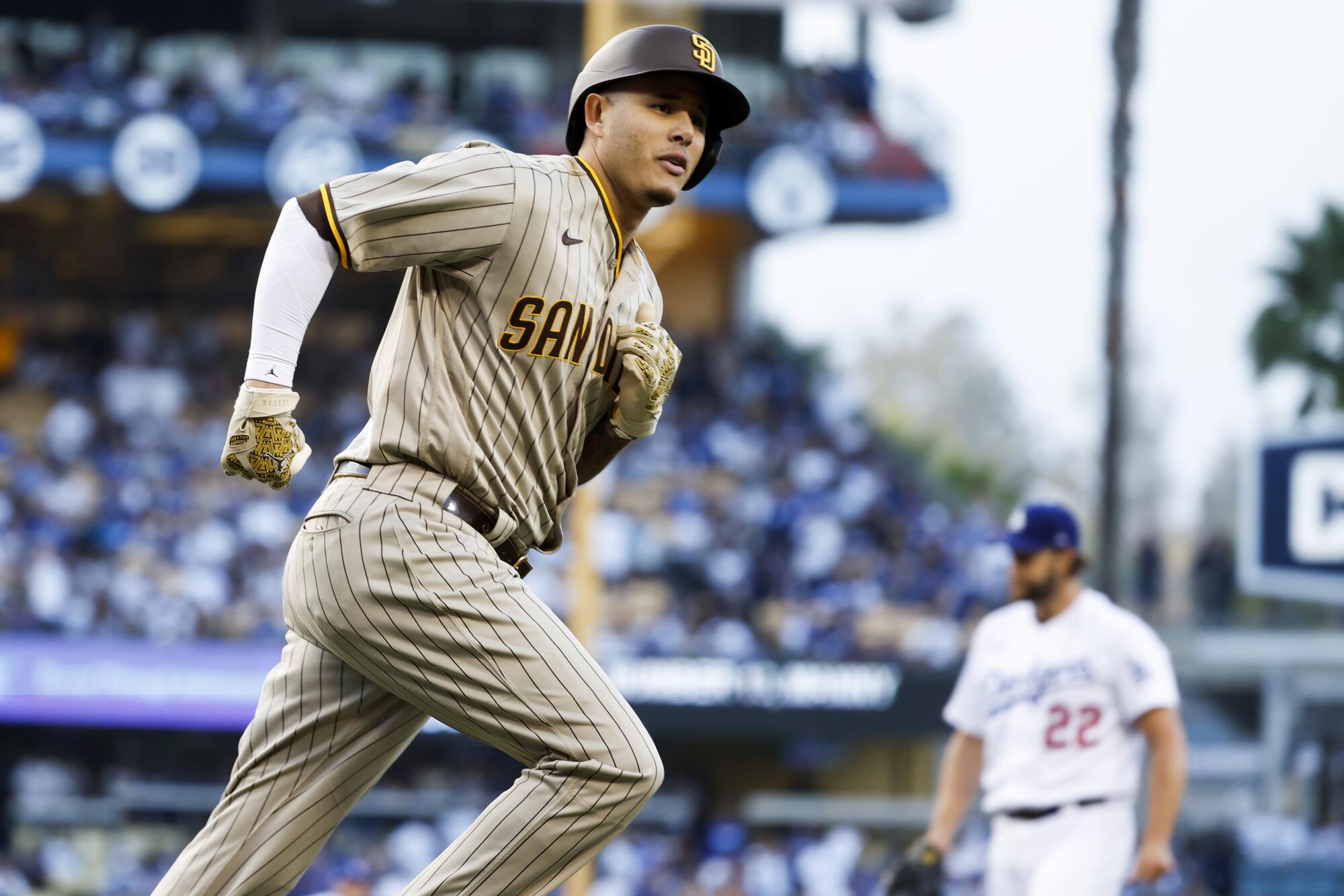 Manny Machado of the San Diego Padres rounds the bases after