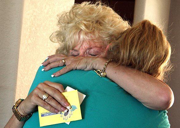 Candy Kessler, left, hugs daughter Deanna Steidl after moving with her husband into their home at the Oakridge Mobile Home Park in Sylmar.
