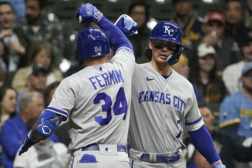 Kansas City Royals' Freddy Fermin is congratulated by Bobby Witt Jr. after hitting a home run during the seventh inning of a baseball game against the Milwaukee Brewers Friday, May 12, 2023, in Milwaukee. (AP Photo/Morry Gash)