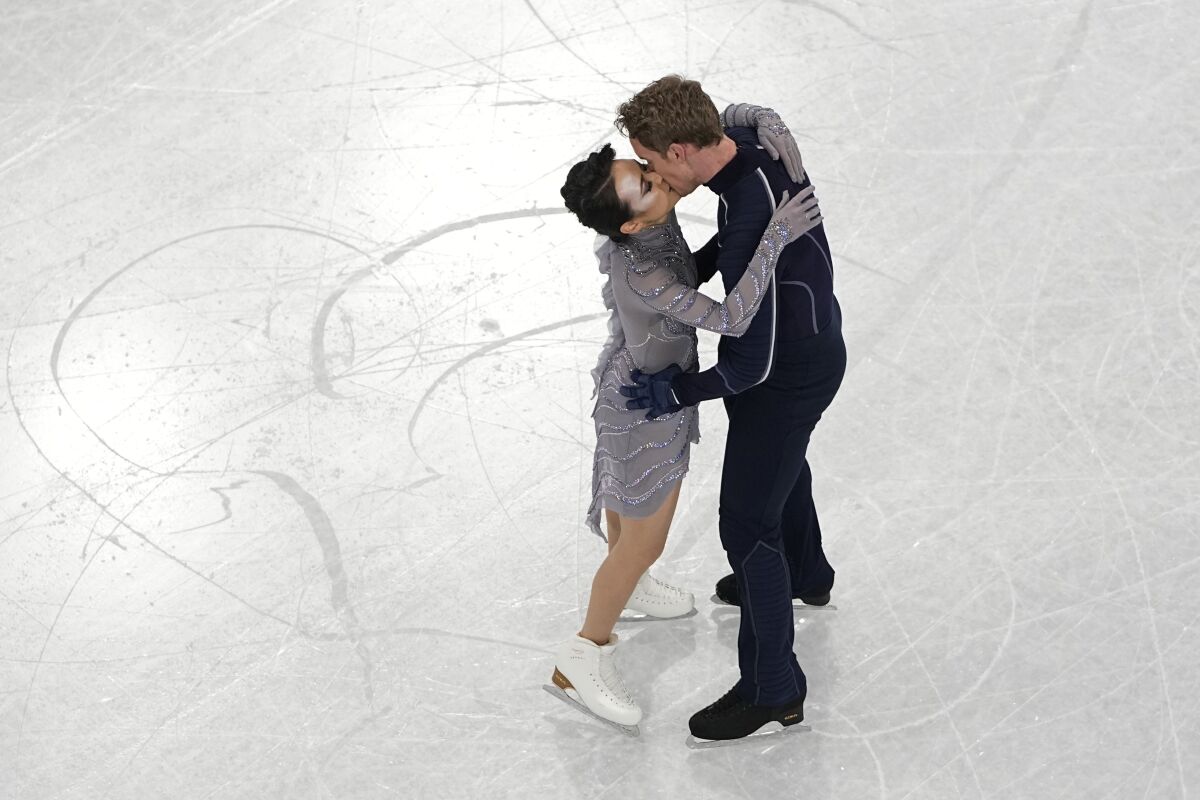 Madison Chock and Evan Bates, of the United States, kiss after completing their routine in the team ice dance program during the figure skating competition at the 2022 Winter Olympics, Monday, Feb. 7, 2022, in Beijing. (AP Photo/Jeff Roberson)
