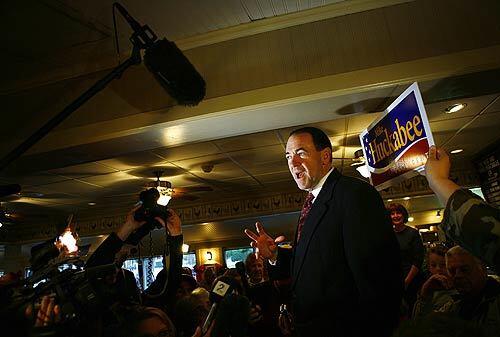 Former Arkansas Gov. Mike Huckabee greets potential voters at Lizard's Thicket, a restaurant in Columbia, S.C., in early December. The former Southern Baptist preacher was once considered a longshot in the Republican presidential race but has enjoyed a surge in the polls. During his 10½ years as governor of Arkansas, he was regarded as a different brand of Republican  a governor with an idiosyncratic agenda that was sometimes difficult to categorize, but always shaped by his religious beliefs.