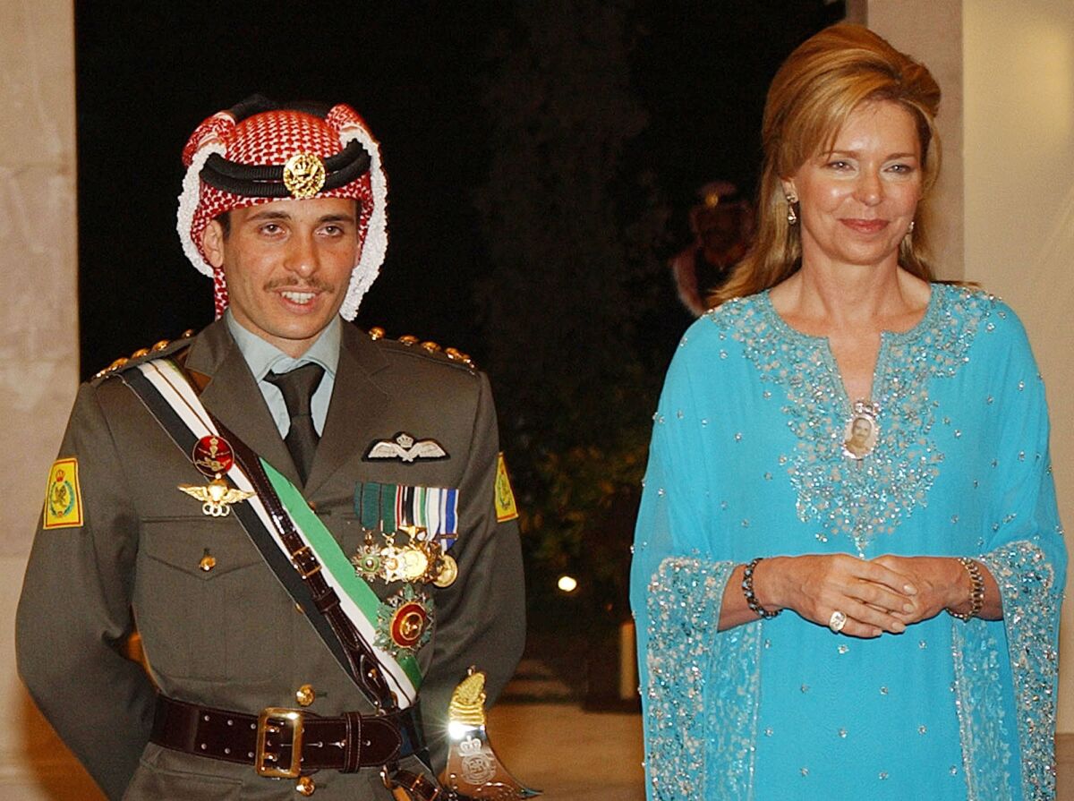 Jordan's former crown prince, Hamzah, left, stands next to his mother, Queen Noor, in 2004.