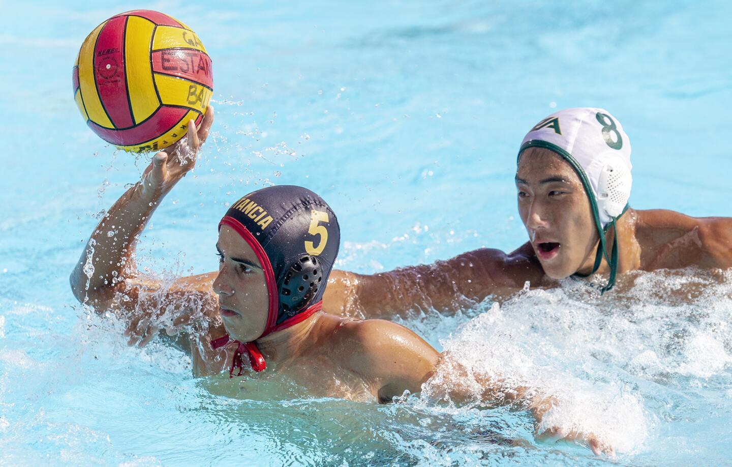 Estancia's Matthew Kehoe takes a shot under pressure from Rancho Alamitos's Sam Trinh during a nonleague match on Thursday, September 27.
