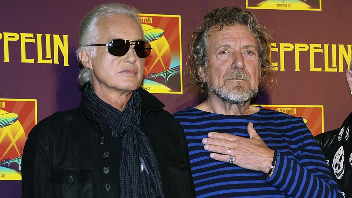 Led Zeppelin guitarist Jimmy Page, left, and singer Robert Plant appear at a news conference ahead of the worldwide theatrical release of "Celebration Day," a concert film of their 2007 London O2 arena reunion show, in New York, in 2012.