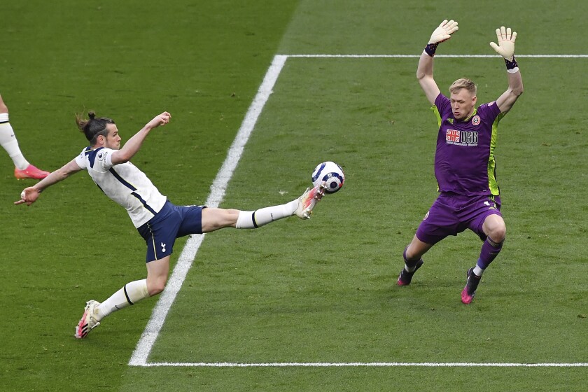 Tottenham's Gareth Bale, left, scores his side's opening goal during the English Premier League soccer match between Tottenham and Sheffield United, at the Tottenham Hotspur Stadium in London, Sunday, May 2, 2021. (Justin Setterfield/Pool via AP)