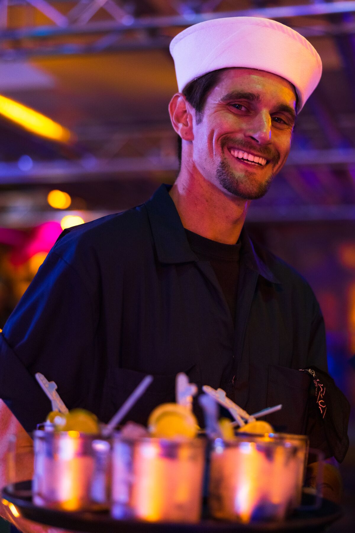 A server at the Acey-Doucey Club, a pop-up submarine tiki bar experience in the Gaslamp Quarter through June 26.