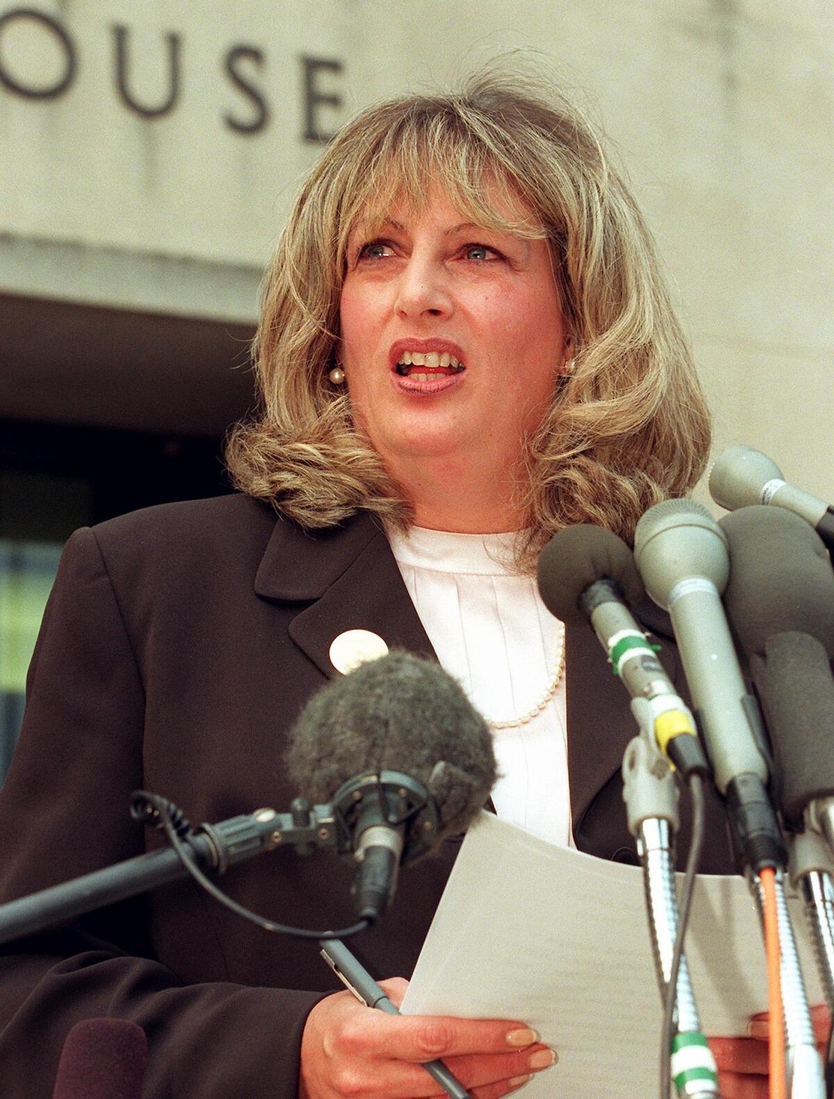 Linda Tripp delivers remarks at a press conference