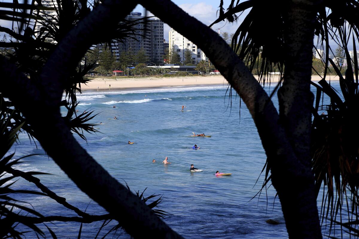 Surfers in the water off of Australia’s Gold Coast