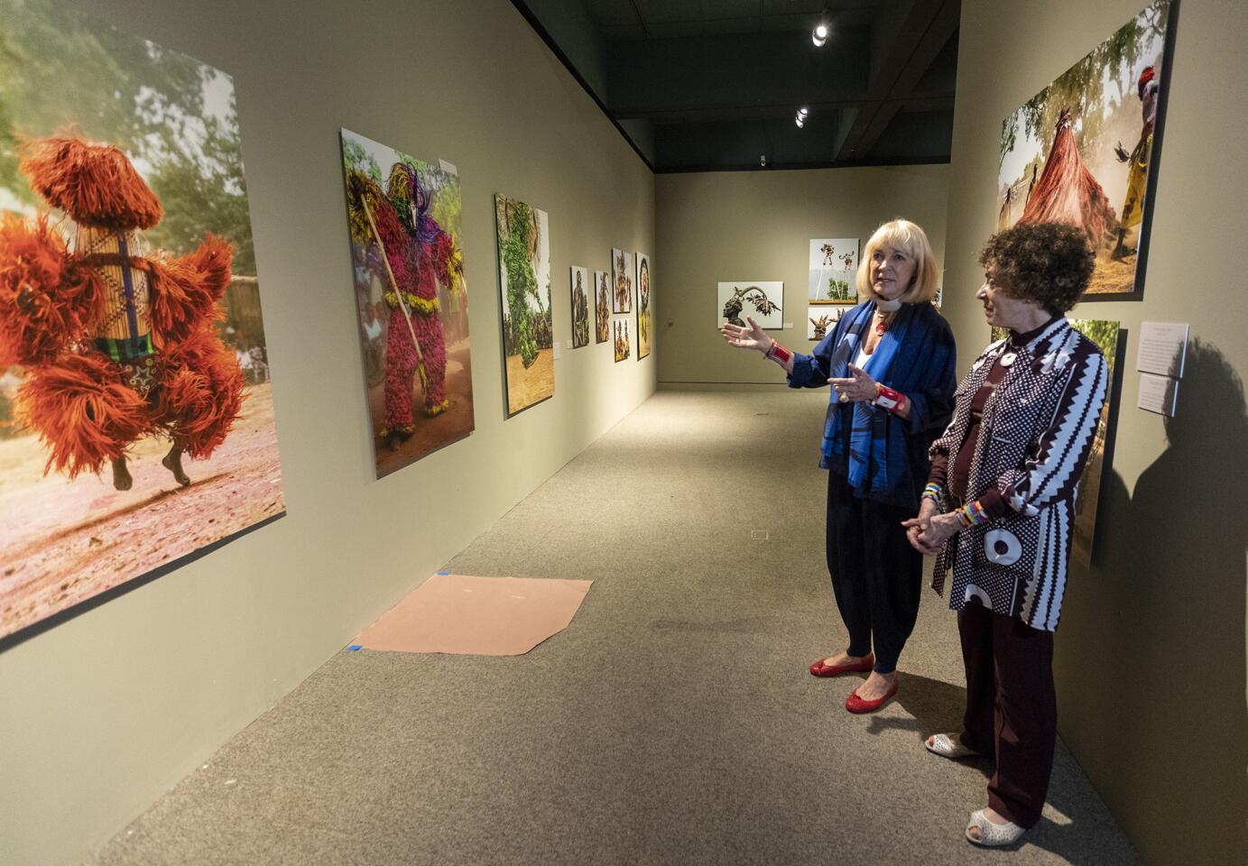 Angela Fisher, left, and Carol Beckwith speak about their exhibit "African Twilight: Vanishing Rituals & Ceremonies" at the Bowers Museum on July 6.