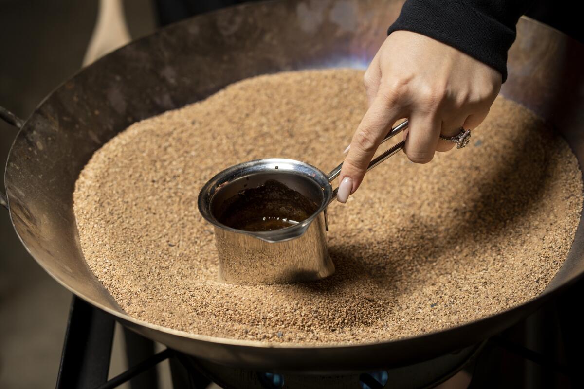 Katie Kevorkian makes sand coffee at the Korner K'nafeh pop-up in Northridge.