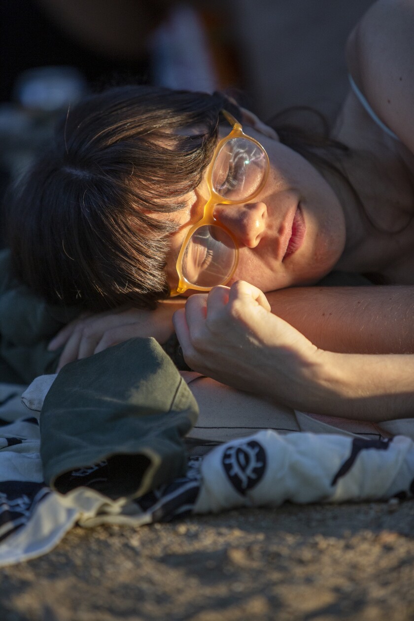 A ray of sunlight on a sleeping woman's face