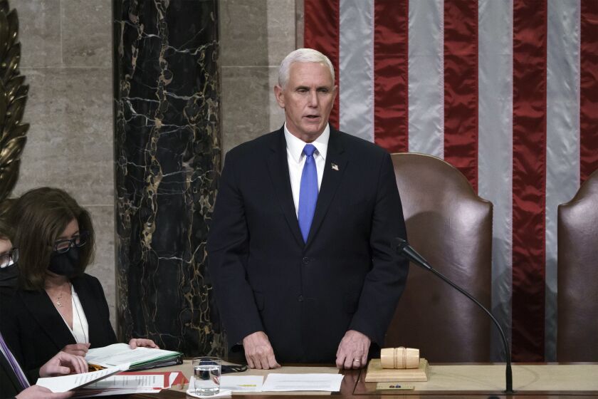 Vice President Mike Pence listens after reading the final certification of Electoral College votes cast in November's presidential election during a joint session of Congress after working through the night, at the Capitol in Washington, Thursday, Jan. 7, 2021. Violent protesters loyal to President Donald Trump stormed the Capitol Wednesday, disrupting the process. (AP Photo/J. Scott Applewhite, Pool)