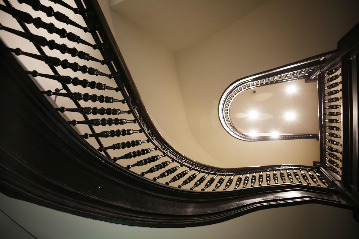 Wrought iron finials of the stairway were restored while preserving original architectural details