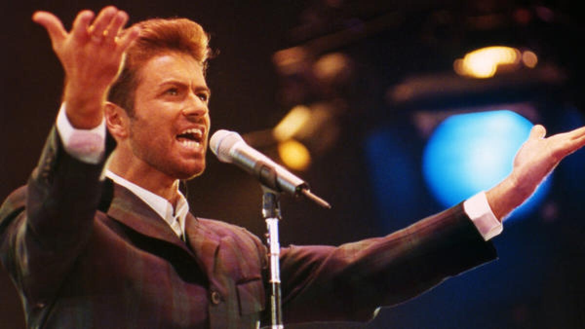 Singer George Michael performs in front of 11,000 people to mark World AIDS Day at London's Wembley Arena in 1993.