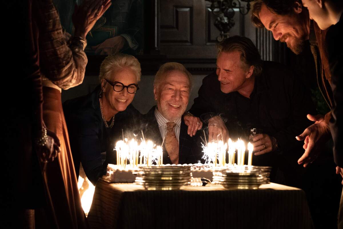 Christopher Plummer faces a giant birthday cake full of lit candles in 'Knives Out.'