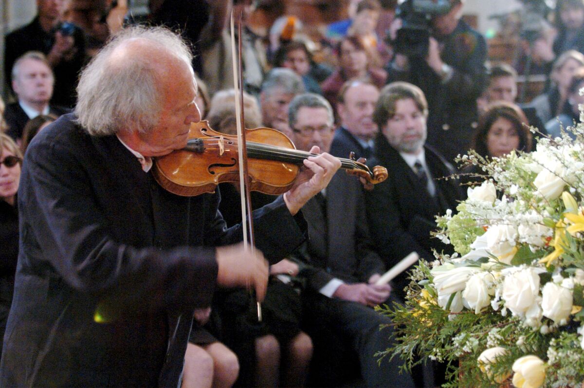 Israeli violinist Ivry Gitlis plays at the funeral of Peter Ustinov in 2004. 