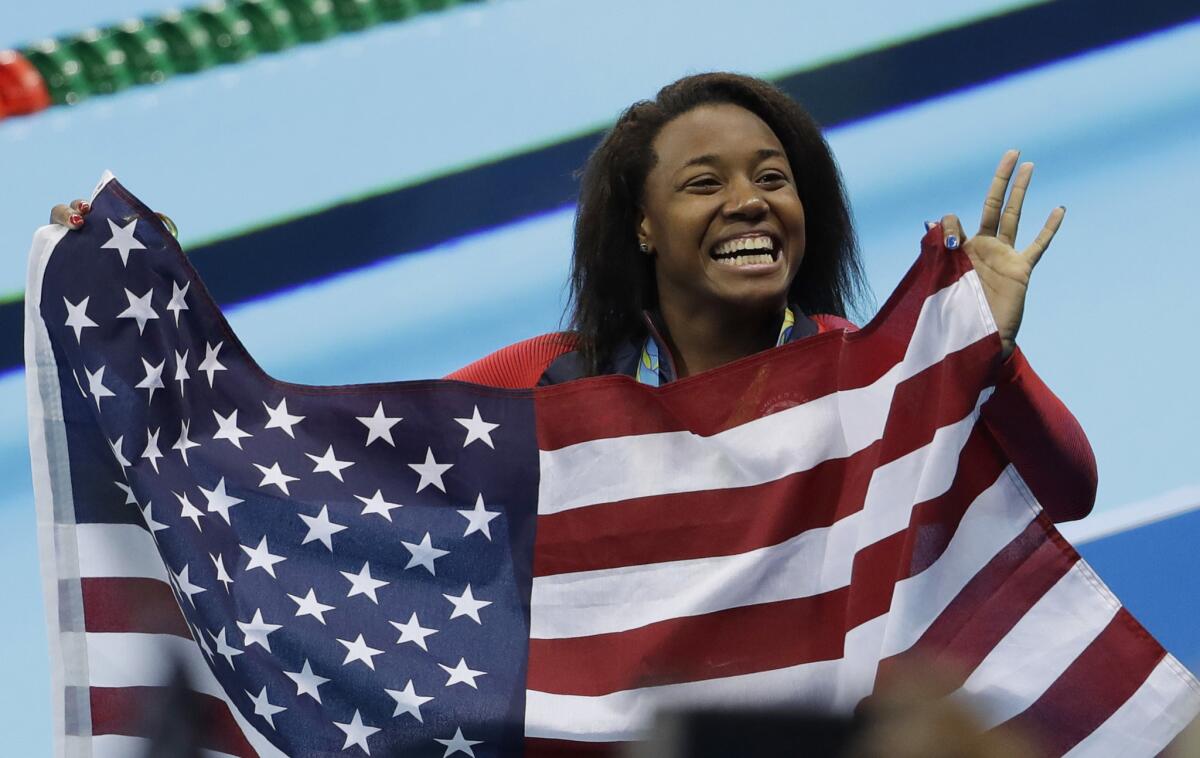 U.S. swimmer Simone Manuel celebrates winning the gold medal in the women's 100-meter freestyle at the Olympic Aquatics Stadium on Aug. 12.