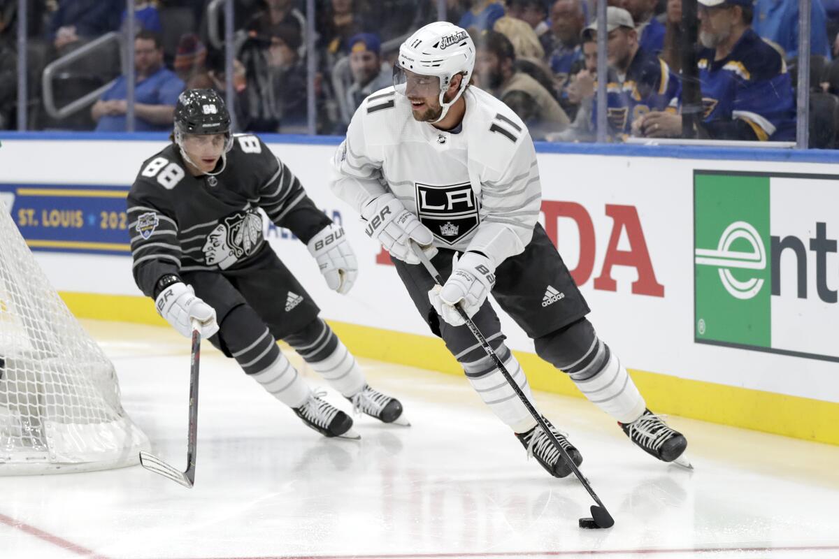 The Kings' Anze Kopitar handles the puck for the Pacific Division team as the Blackhawks' Patrick Kane of the Central Division trails Jan. 25, 2020.