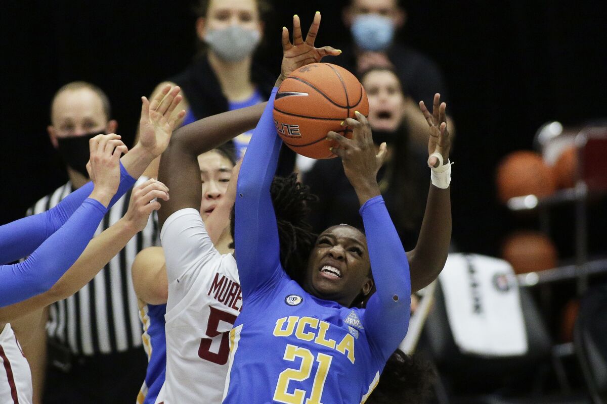 UCLA's Michaela Onyenwere (21) battles for a rebound during the second half Feb. 5, 2021.