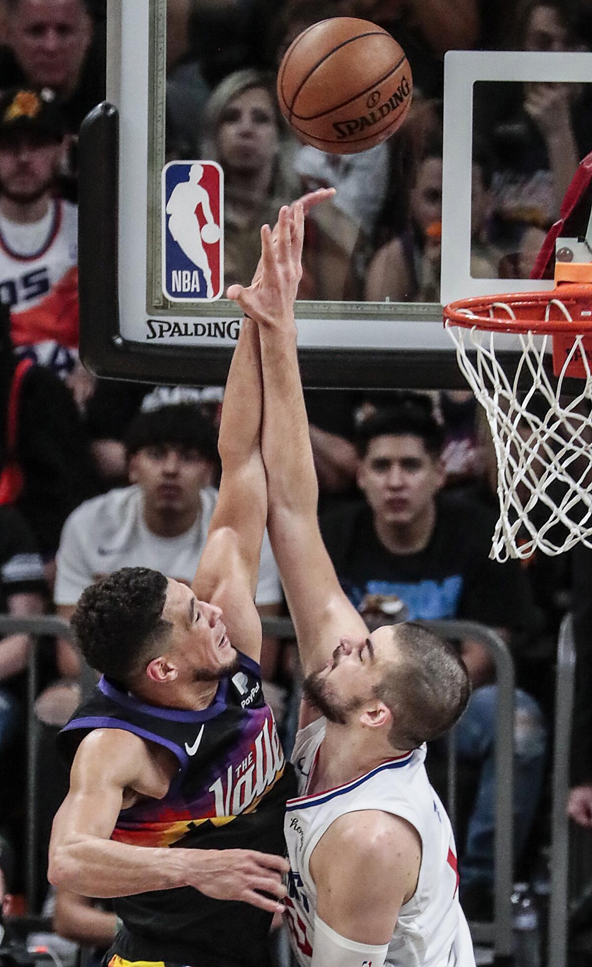 Clippers center Ivica Zubac (40) blocks a dunk attempt by Suns guard Devin Booker.