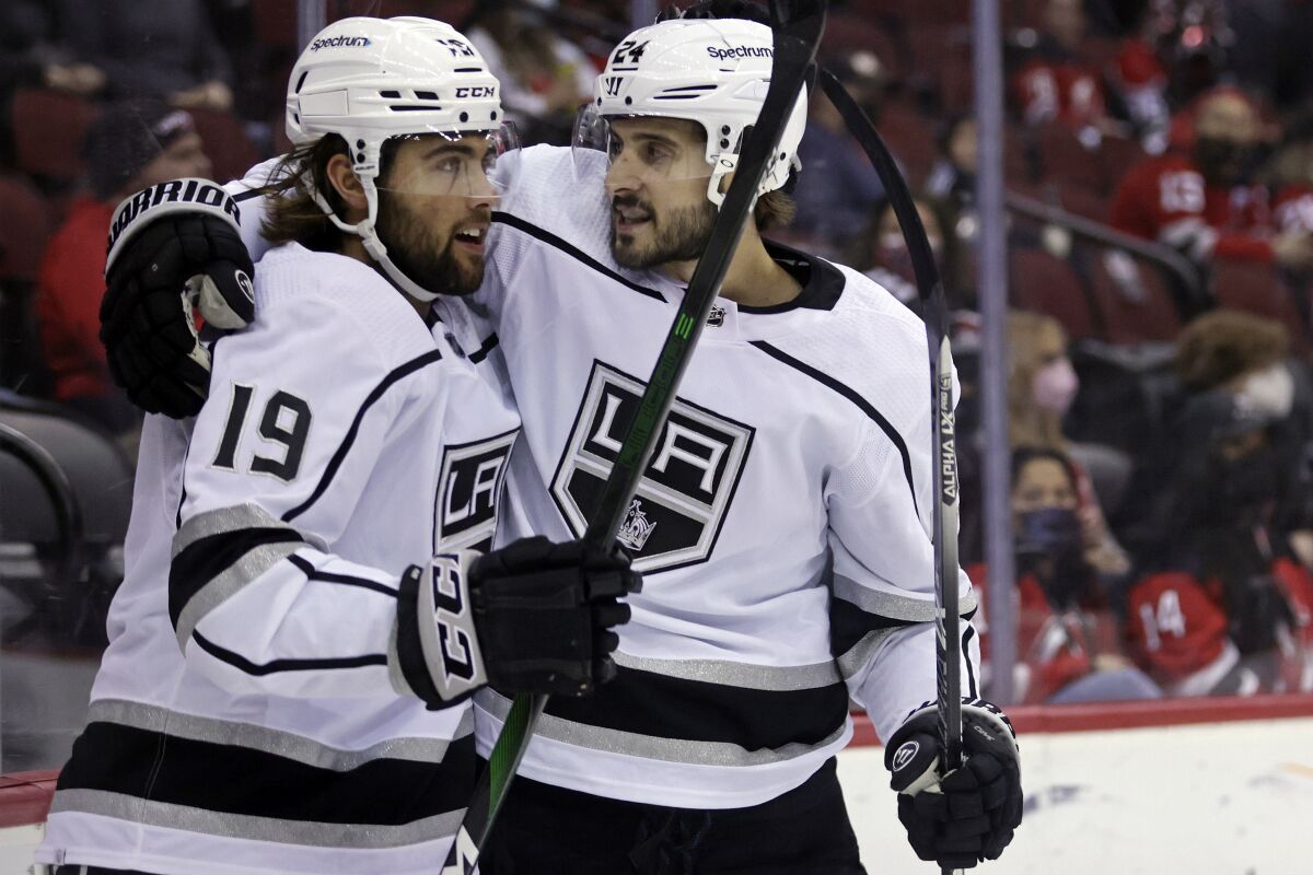 Kings forwards Alex Iafallo and Phillip Danault celebrate a goal.