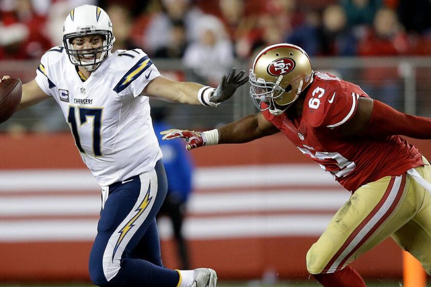 Chargers quarterback Philip Rivers (17) is chased from the pocket by 49ers defensive end Tony Jerod-Eddie in the fourth quarter Saturday night at Levi's Stadium.