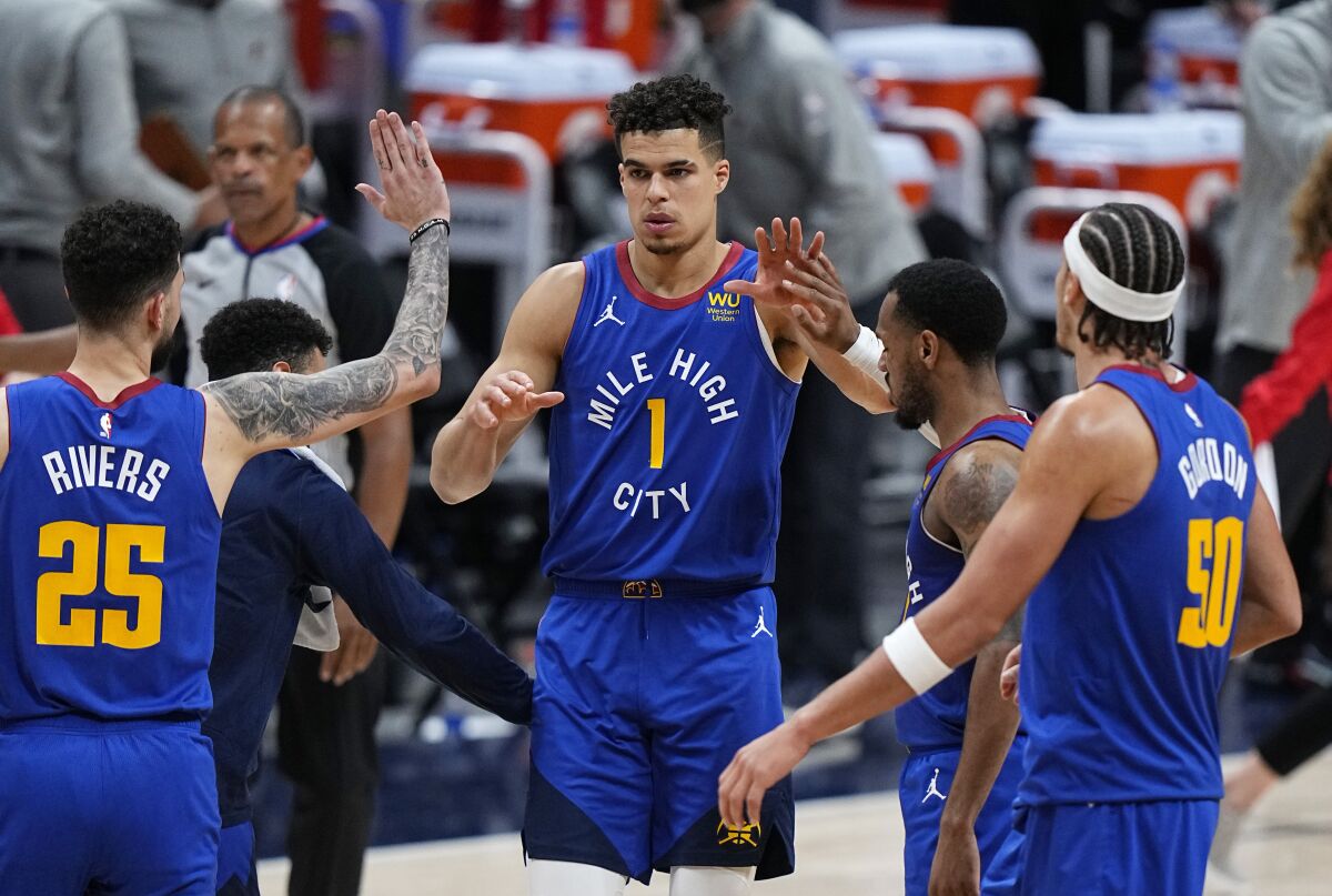 Denver Nuggets forward Michael Porter Jr. (1) is congratulated after hitting a 3-point basket against the Portland Trail Blazers in the second overtime during Game 5 of a first-round NBA basketball playoff series Tuesday, June 1, 2021, in Denver. (AP Photo/Jack Dempsey)
