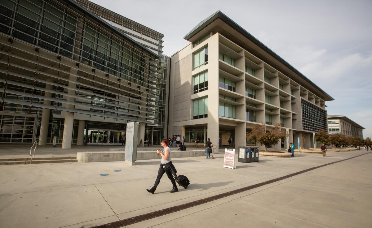 Passersby walk UC Merced's campus 