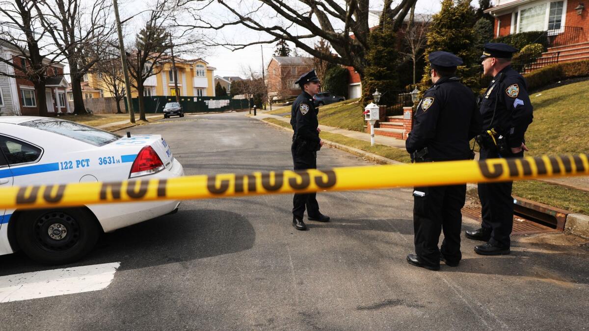 Police stand near the site where reputed mob boss Francesco Cali was gunned down in front of his Staten Island house on March 14, 2019.