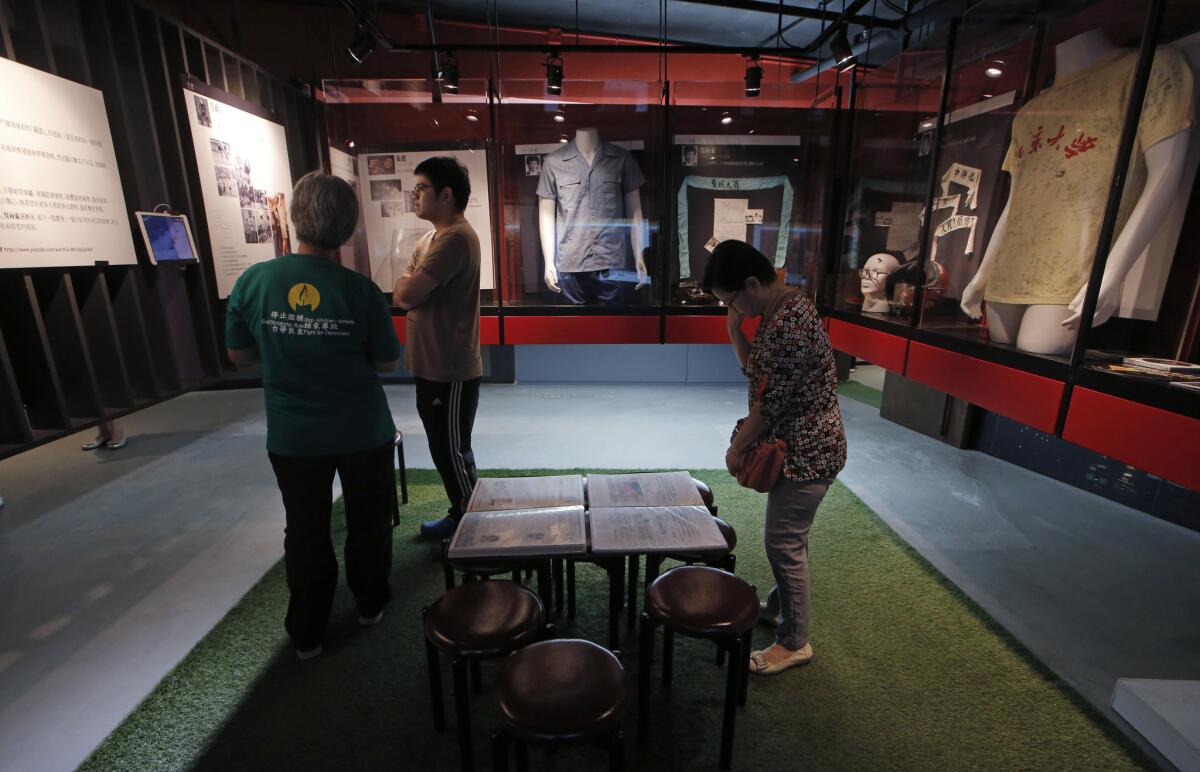 Visitors look at the exhibits in the June 4th Museum in Hong Kong on April 15, 2016.