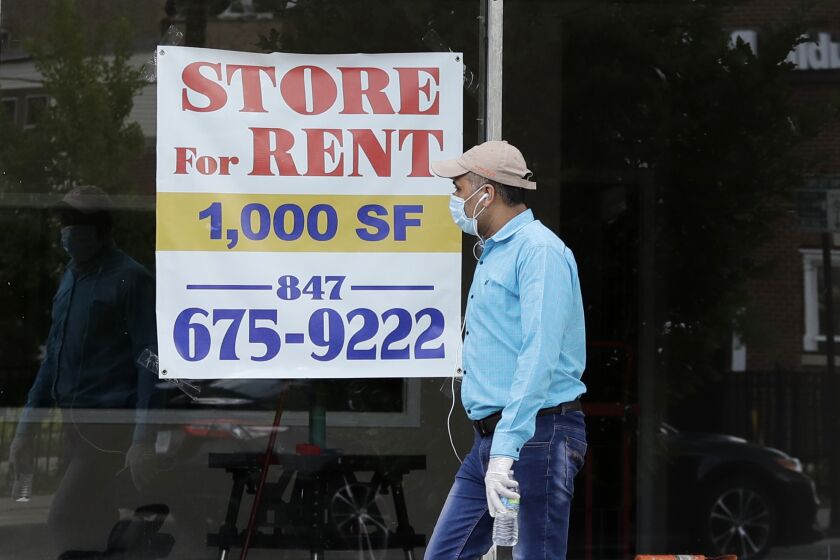 FILE - In this June 20 2020 file photo, a "Store For Rent" sign is displayed at a retail property in Chicago. The U.S. economy shrank at a 5.0% rate in the first quarter with a much worse decline expected in the current three-month economic period because of the coronavirus pandemic. (AP Photo/Nam Y. Huh)