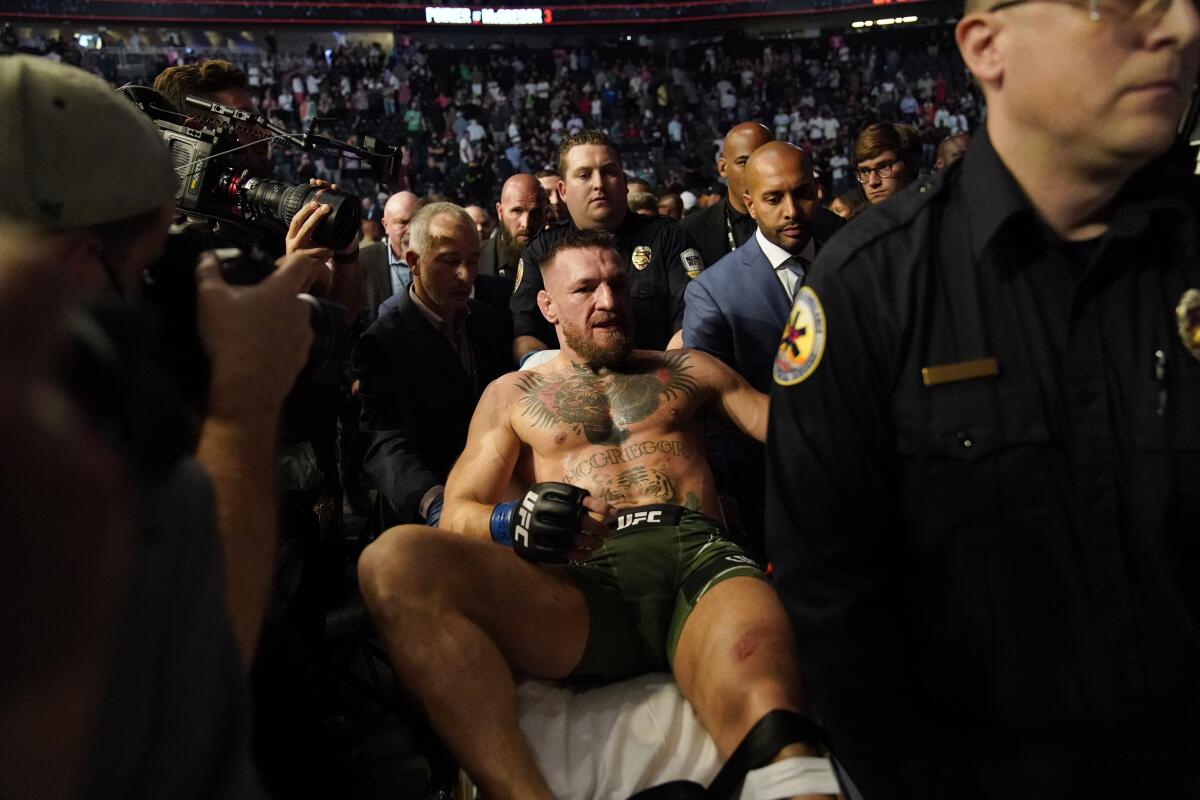 Conor McGregor is carried off on a stretcher 