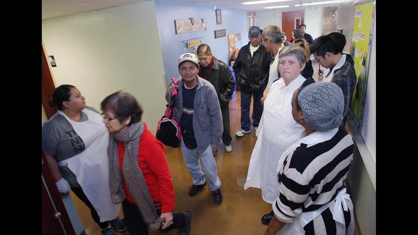 The doors are opened and guests file in at the Salvation Army Glendale Corps and Community Center Thanksgiving dinner in Glendale on Thursday, Nov. 26, 2015.