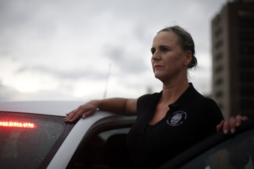 LOS ANGELES, CA-MARCH 12, 2020: LAPD officer Stacy Pierce-Rogers works in the department's mental evaluation unit and poses with a car she uses to respond to incidents on March 12, 2020 in Los Angeles, California. The unit where she works is made up of so-called "SMART' teams where officers partner with a county mental health specialist to respond to calls. (Photo By Dania Maxwell / Los Angeles Times)