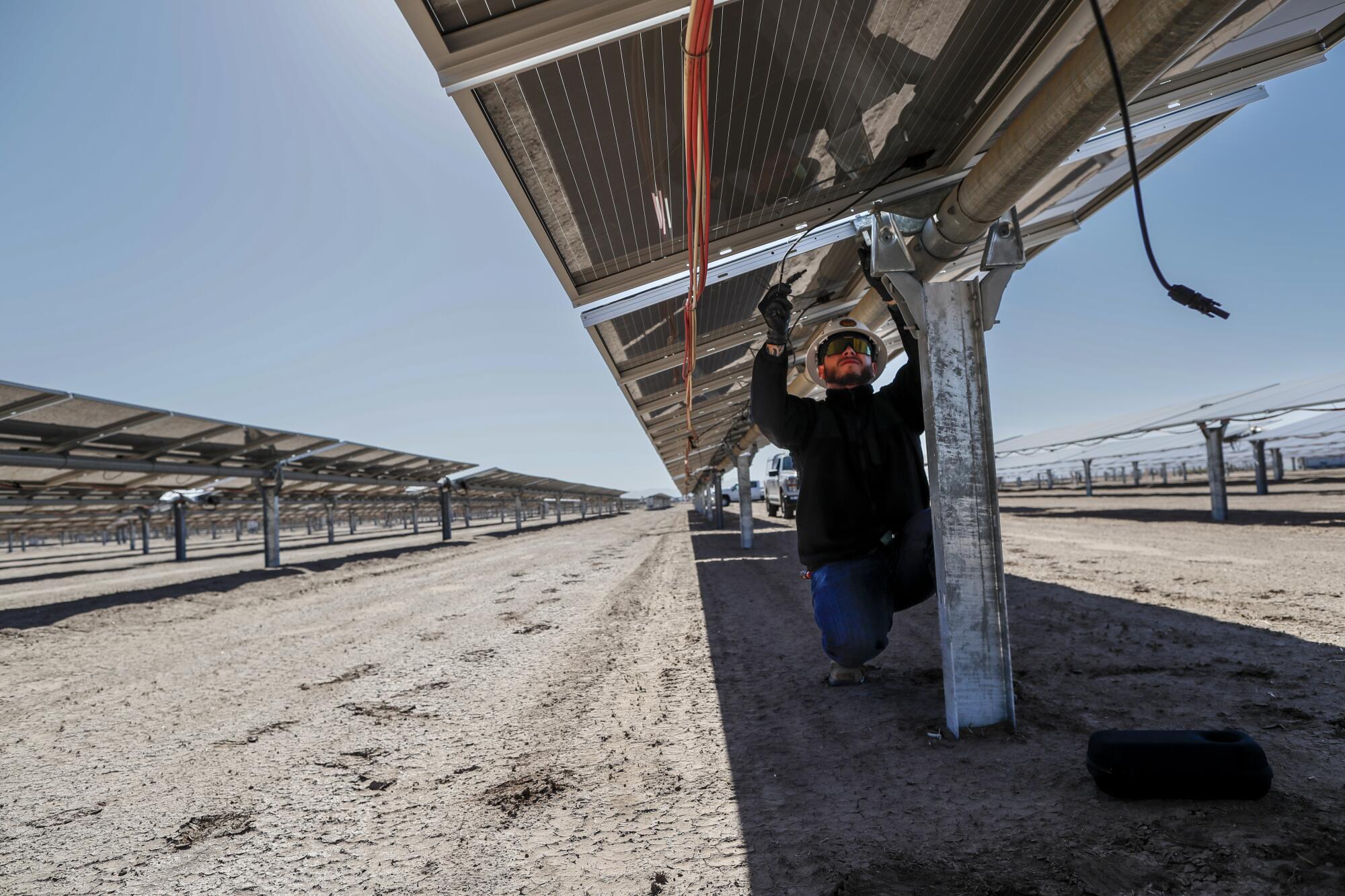 Technician Junior Lopez performs maintenance at Arevon's Mt. Signal 3 solar farm in the Imperial Valley.
