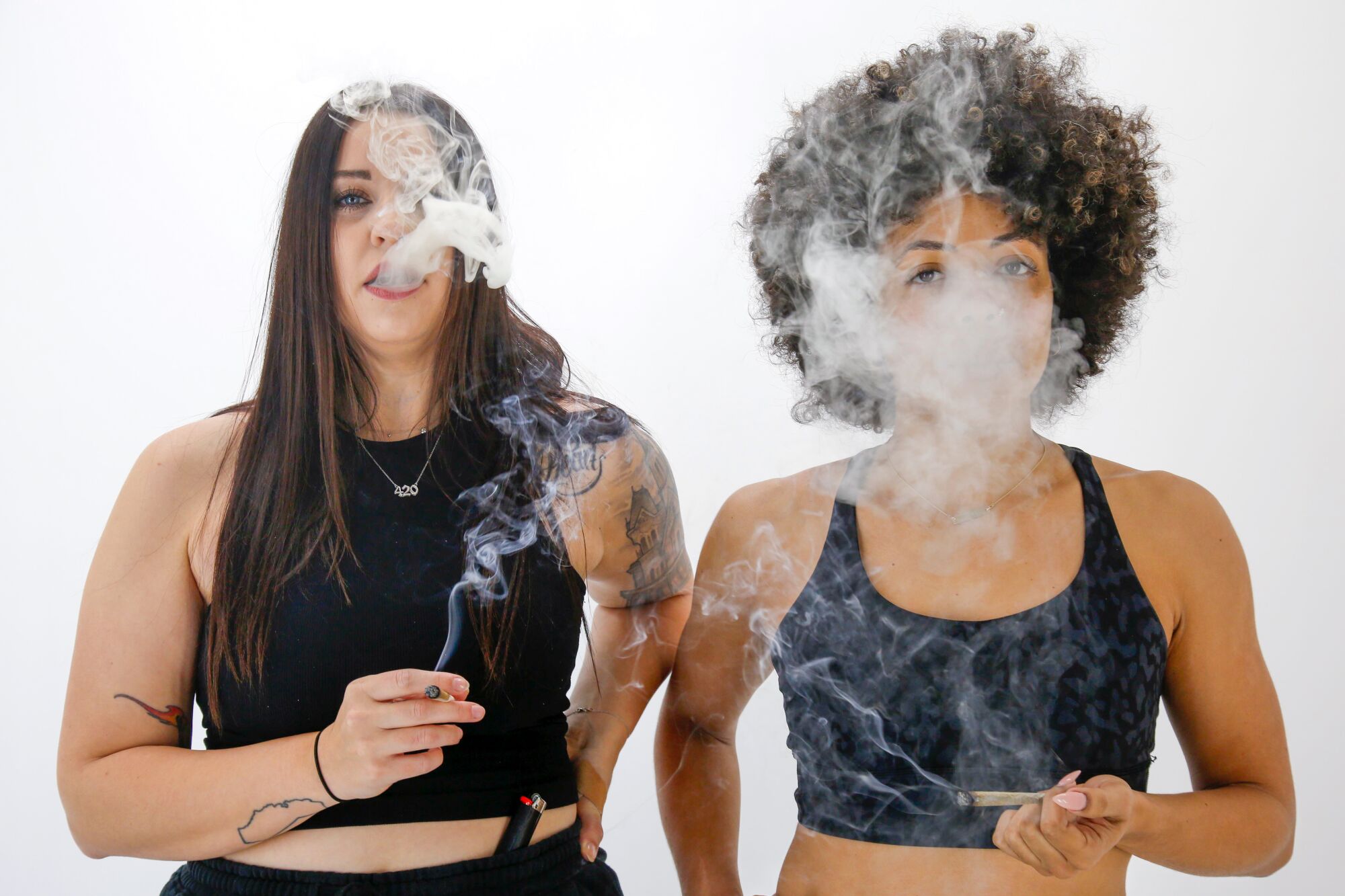 Stoned + Toned instructors Morgan English, left, and Bree Deanine take a hit at the start of their online workout.
