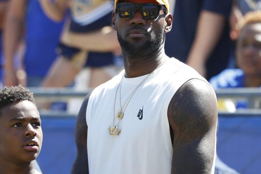 LeBron James and son Bronny watch from the sideline during a game between the Rams and Seattle Seahawks in September 2016.