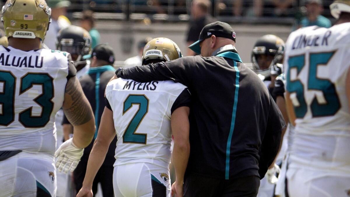 Jacksonville Jaguars Coach Gus Bradley talks to kicker Jason Myers after he missed an extra point during the first half of their 20-9 loss to the Carolina Panthers on Sunday.