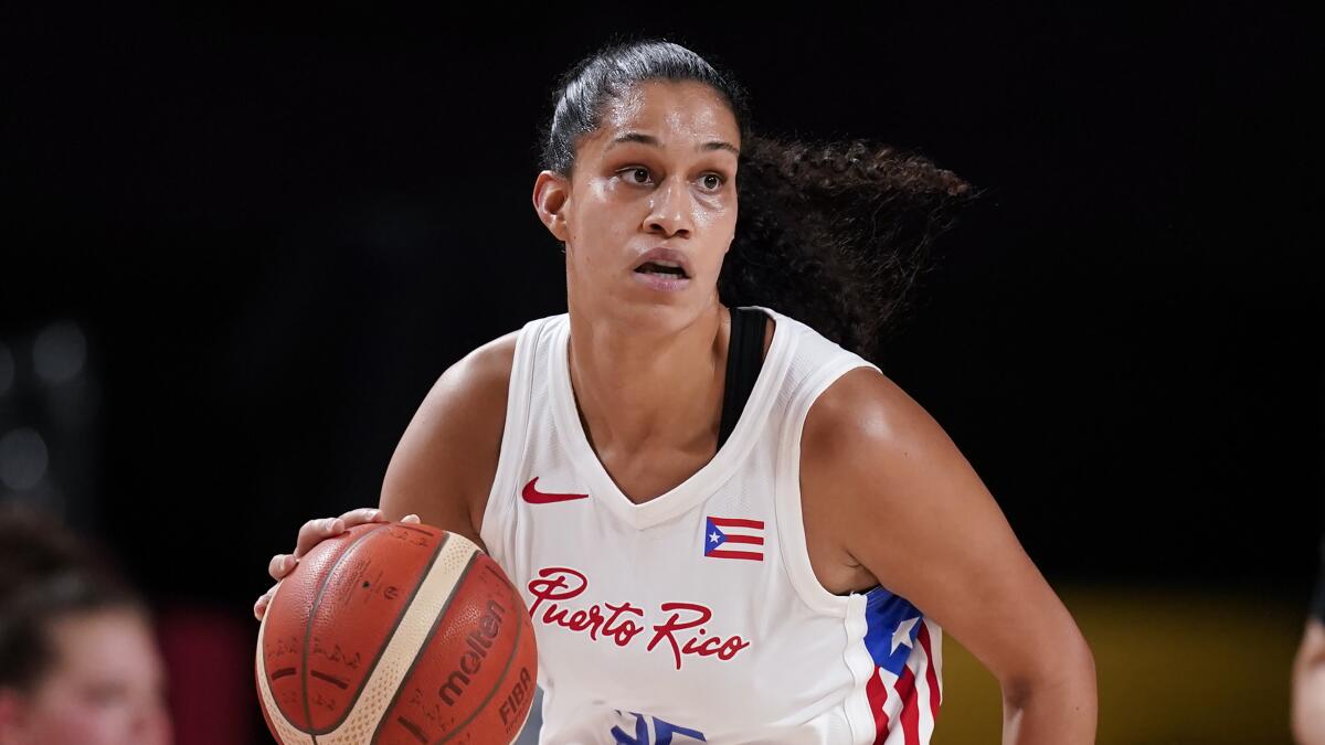 Puerto Rico's Isalys Quinones dribbles a basketball while looking up.