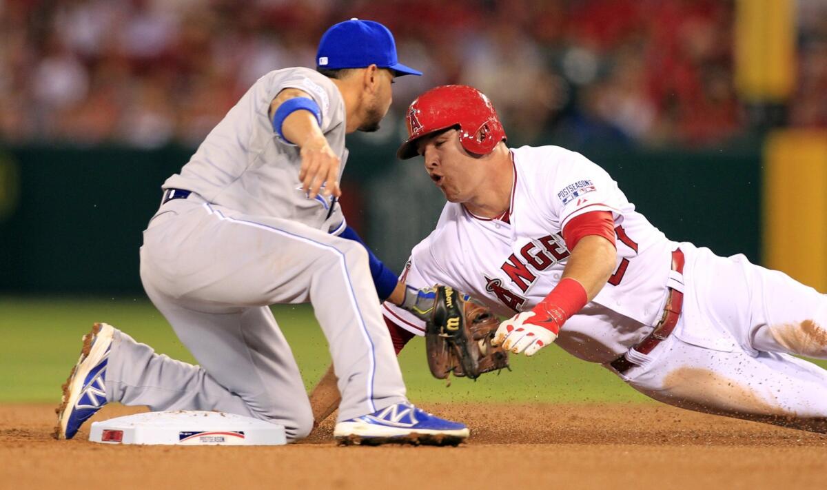 Mike Trout is tagged out by Kansas City second baseman Omar Infante while attempting to steal in the first inning of Game 2 of the American League division series. Trout is 0-for-8 in the first two games of the series.