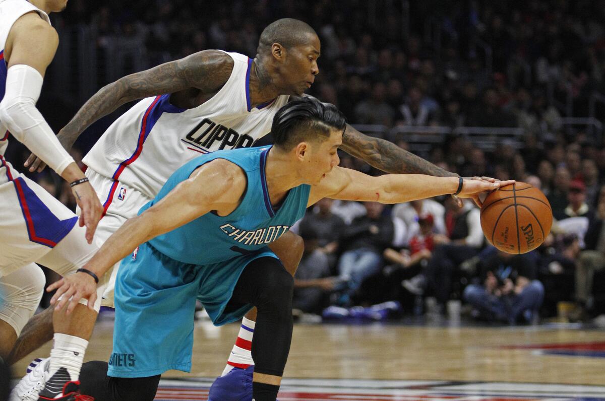 Clippers guard Jamal Crawford tries to steal the ball from Hornets guard Jeremy Lin (7) during the second half.